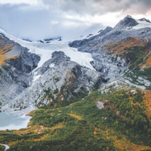 a snow covered mountain range with a lake below